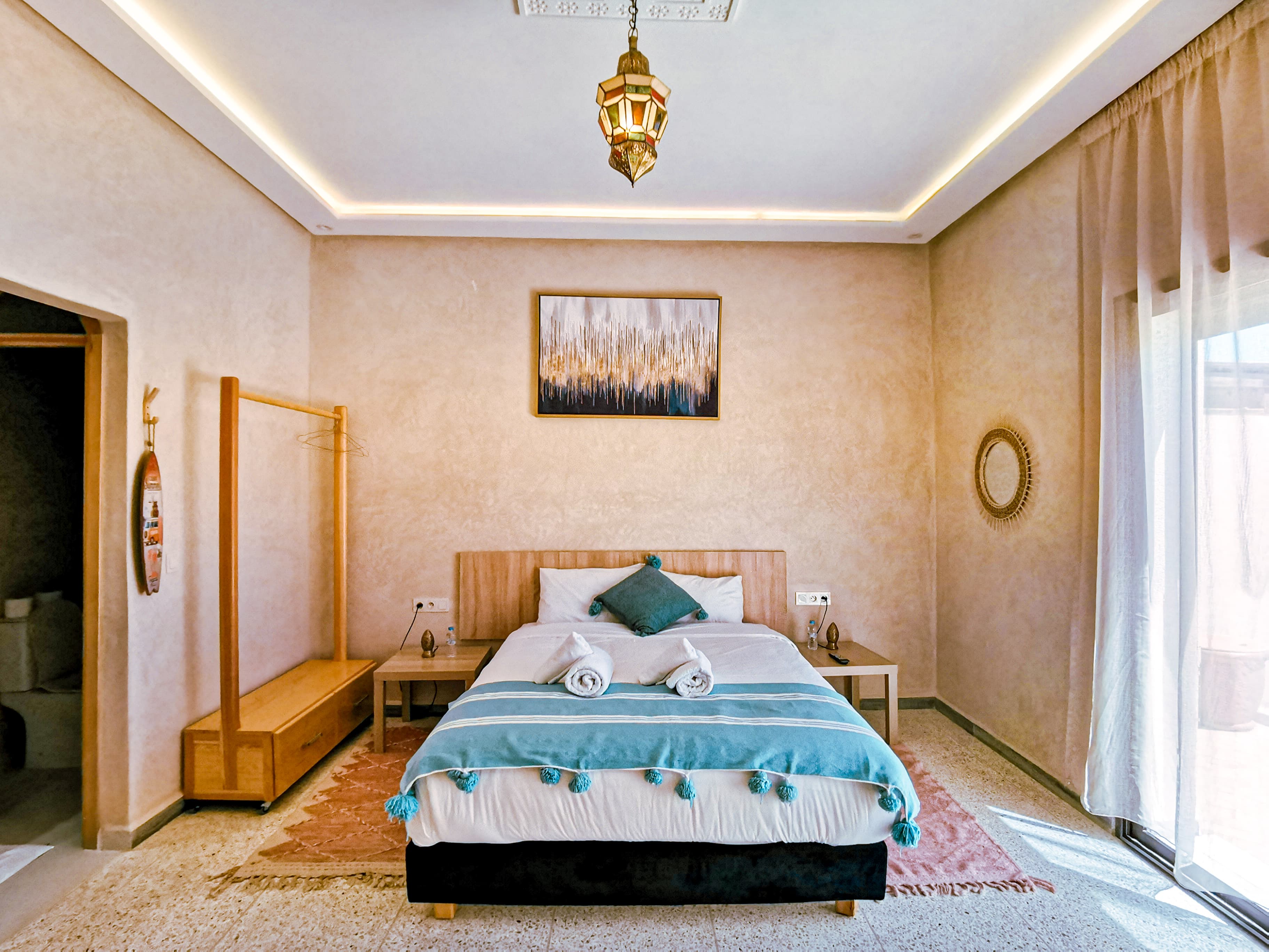 Bedroom with teal accents and lantern