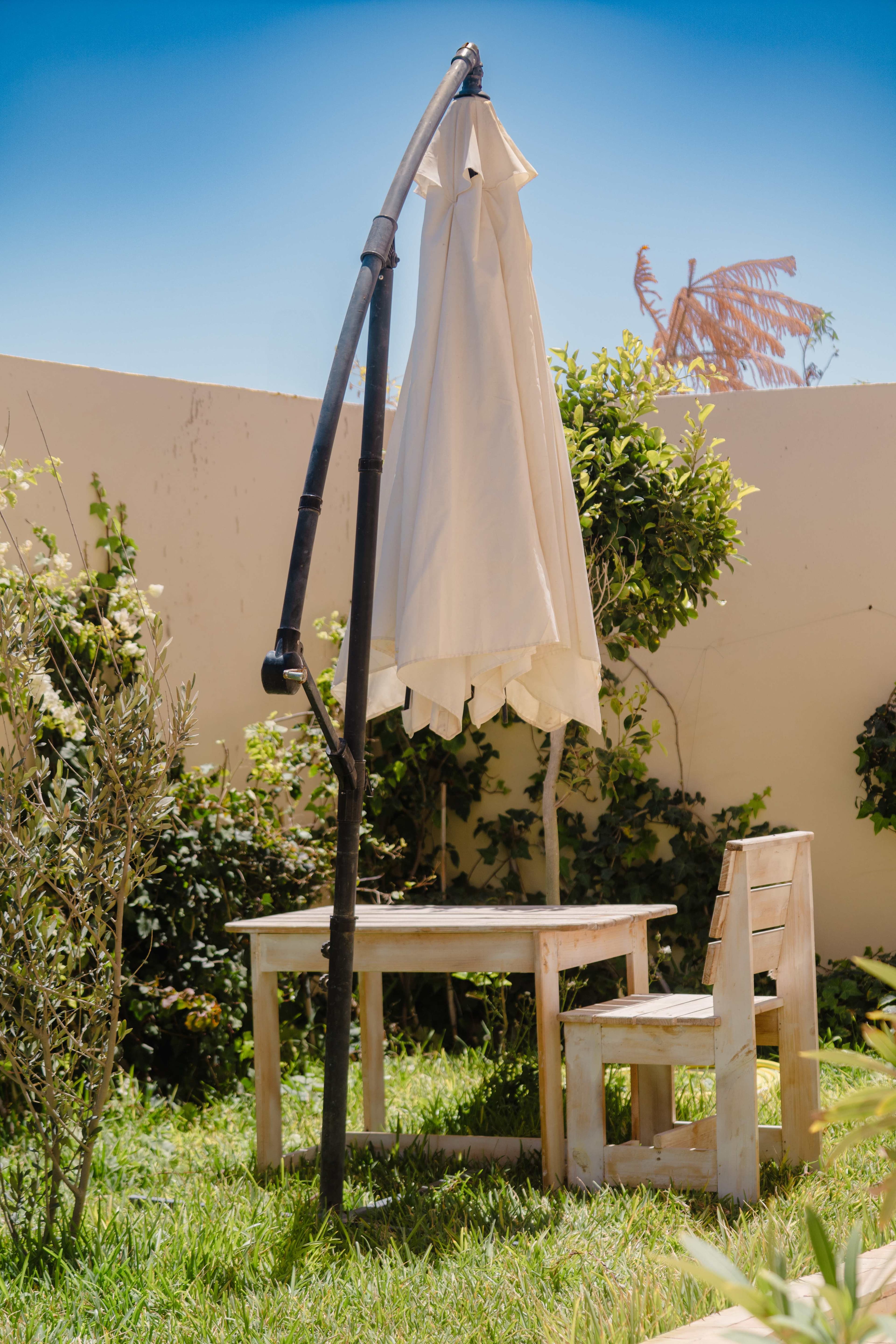 Garden table and chair under parasol