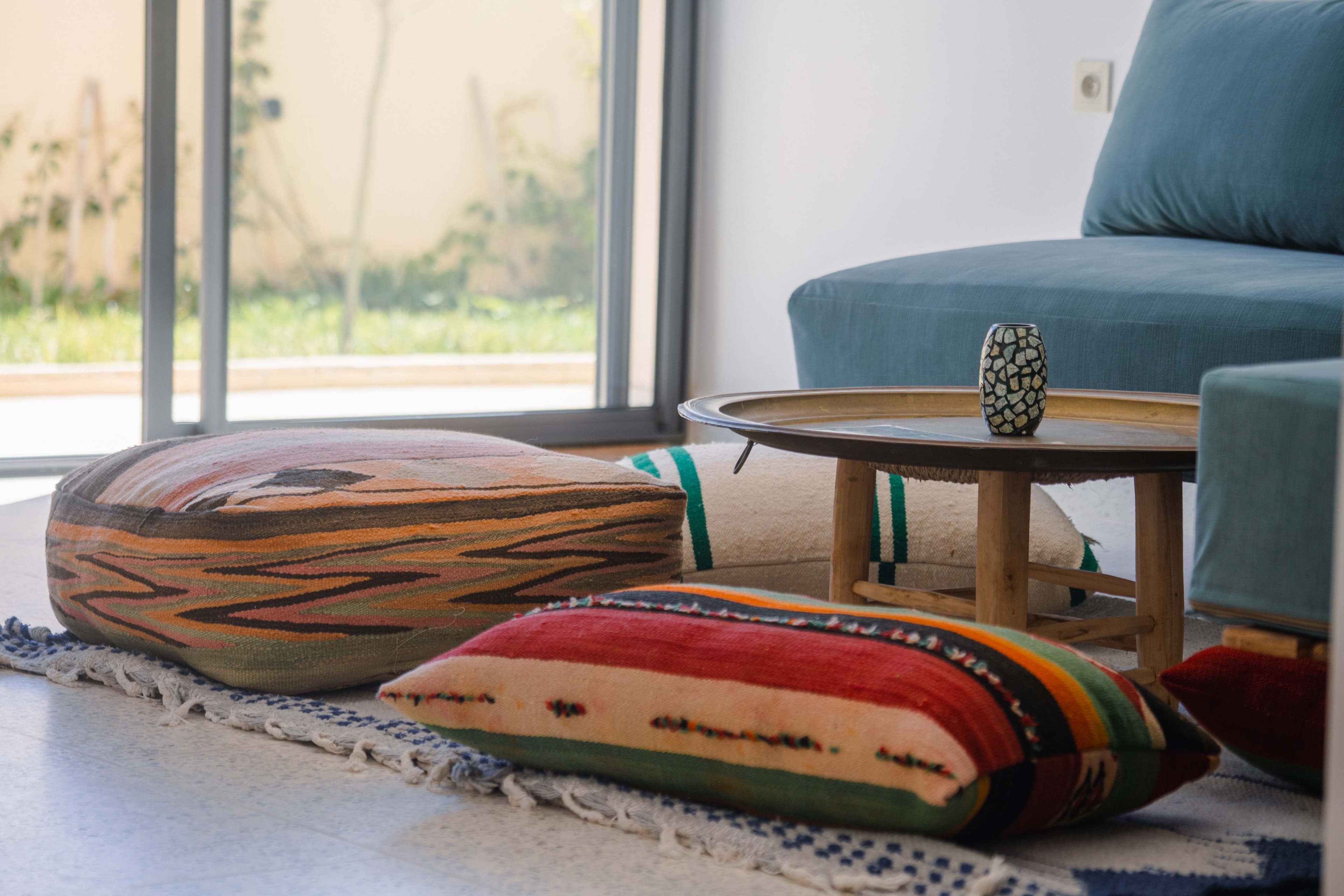 Colorful floor cushions and living area